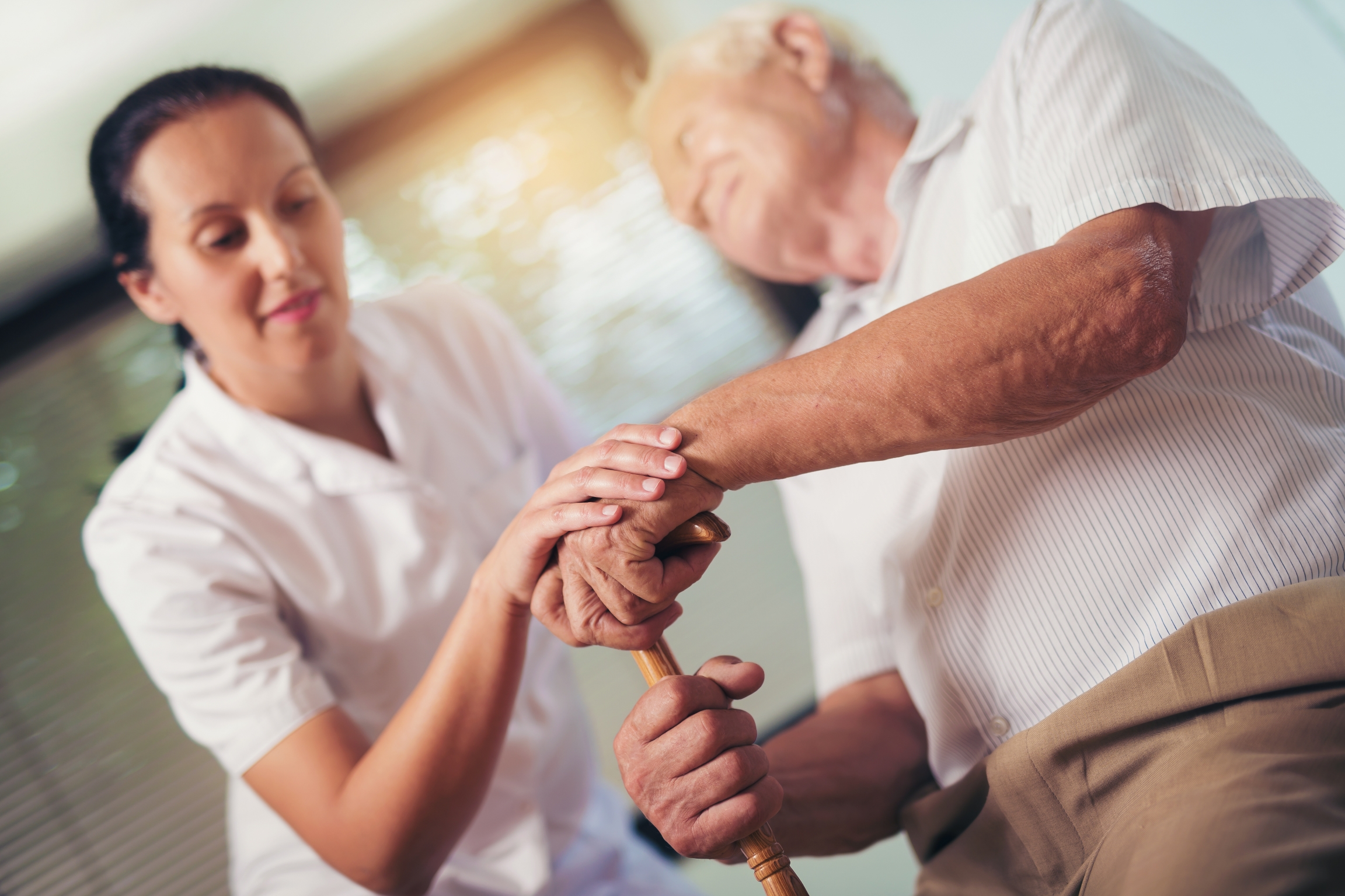 Happy Elderly Man with Assistance from Nurse